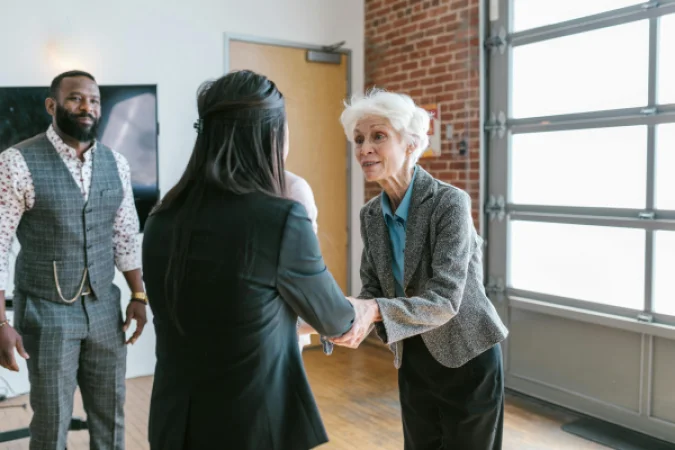 Entrepreneurs shaking hands after a meeting, representing a successful deal.